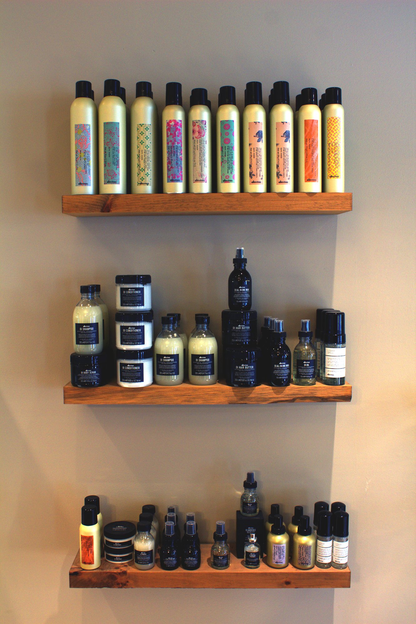 Davines products on wooden floating shelves