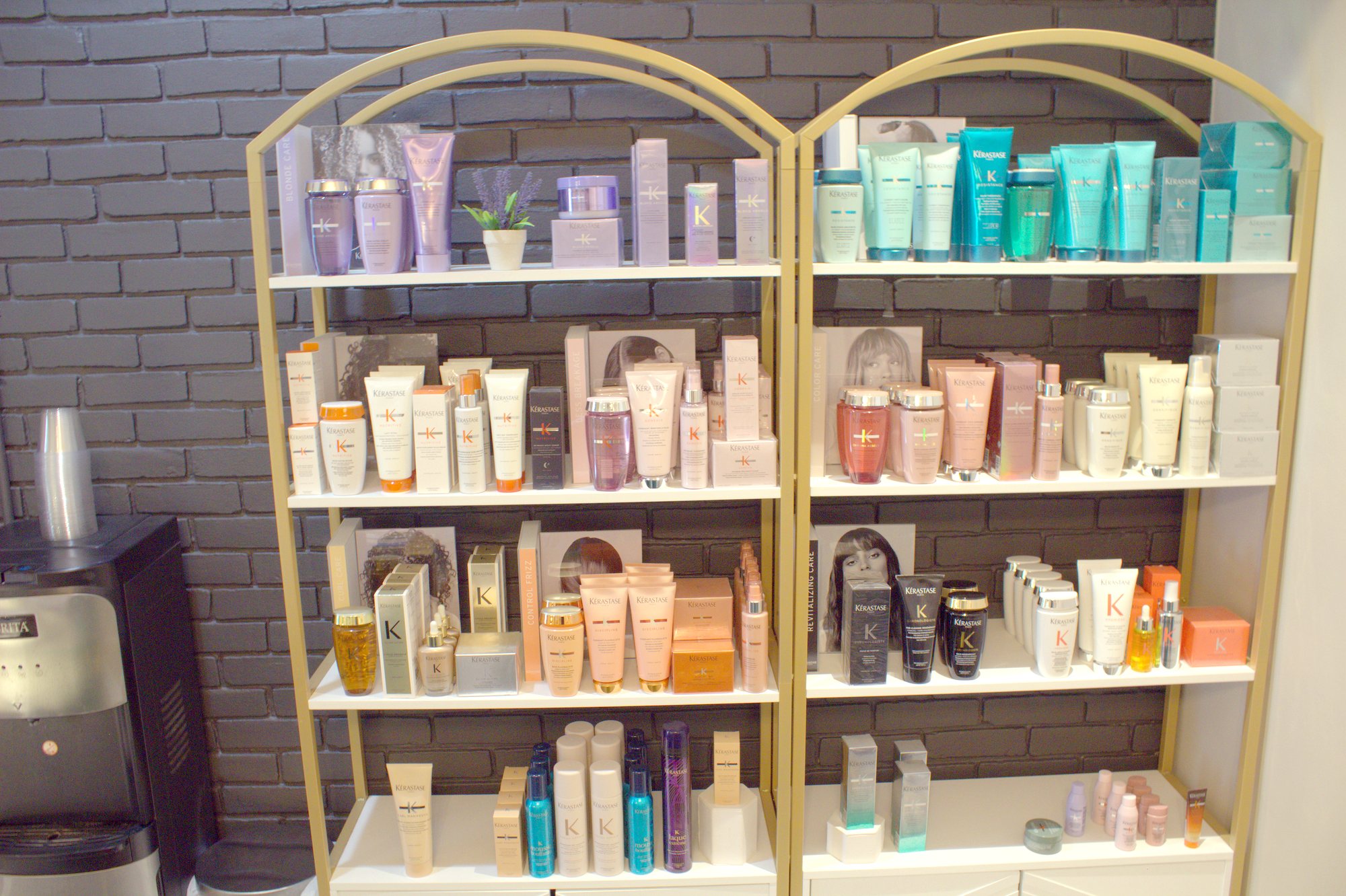 The Kérastase wall on gold arched shelves