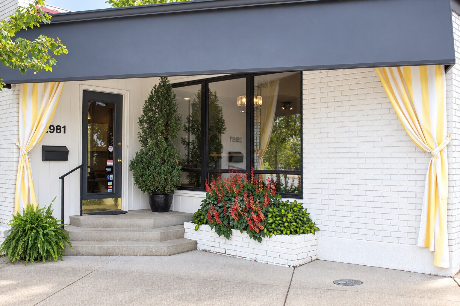 The front of Hair, Inc. at 2981 Madison Rd., with red flowers by the steps